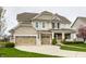 Charming two-story home with a three-car garage and manicured lawn at 12624 Teaberry Ln, Carmel, IN 46032