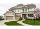 Charming two-story home with a three-car garage and manicured lawn at 12624 Teaberry Ln, Carmel, IN 46032
