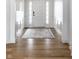 Bright foyer with a white paneled accent wall, hardwood floors, and large rug at 12624 Teaberry Ln, Carmel, IN 46032
