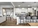 Open kitchen design with a central island, white cabinetry, and seamless flow to other living spaces at 12624 Teaberry Ln, Carmel, IN 46032