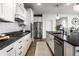 Modern kitchen with white cabinets, subway tile backsplash, stainless steel appliances, and a large island at 12624 Teaberry Ln, Carmel, IN 46032