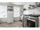 Efficient laundry room with washer, dryer, built-in storage, and natural light at 12624 Teaberry Ln, Carmel, IN 46032
