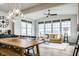 Bright open living area featuring a dining table, modern decor, and large windows with views at 12624 Teaberry Ln, Carmel, IN 46032