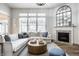 Comfortable living room features fireplace, large windows and modern decor at 12624 Teaberry Ln, Carmel, IN 46032