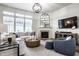 Bright living room with a fireplace, a modern light fixture, and comfortable furniture at 12624 Teaberry Ln, Carmel, IN 46032