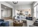 Open-concept living room featuring modern furnishings and neutral decor, flowing into the kitchen at 12624 Teaberry Ln, Carmel, IN 46032