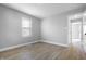 Cozy bedroom featuring light-colored walls and modern flooring with a hallway entrance at 1323 S Ewing St, Indianapolis, IN 46203