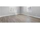 Bright bedroom with two windows and modern, light-colored flooring at 1323 S Ewing St, Indianapolis, IN 46203