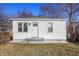 A cozy, quaint home featuring a white exterior, well-maintained lawn and welcoming front entrance at 1323 S Ewing St, Indianapolis, IN 46203