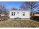 Charming exterior view of home featuring a white facade, well-kept yard and front entryway at 1323 S Ewing St, Indianapolis, IN 46203