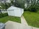 View of the exterior of a one car garage surrounded by a green lawn at 1323 S Ewing St, Indianapolis, IN 46203