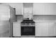 Modern kitchen featuring stainless steel appliances, bright cabinetry, and sleek countertops at 1323 S Ewing St, Indianapolis, IN 46203