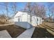 Exterior view of an outbuilding with a garage door, side door, and concrete path at 1323 S Ewing St, Indianapolis, IN 46203