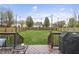 Expansive backyard with a well-maintained lawn, wooden fence, and deck for relaxing and outdoor activities at 14055 Mimosa Ct, Fishers, IN 46038