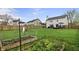 Spacious backyard with a wooden fence, a lush lawn, and raised garden beds at 14055 Mimosa Ct, Fishers, IN 46038