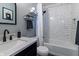 Stylish bathroom featuring modern black fixtures, white subway tile shower, and decor shelves at 14055 Mimosa Ct, Fishers, IN 46038