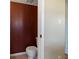 Cozy bathroom featuring a toilet against an accent wall with a neutral-toned floor at 14055 Mimosa Ct, Fishers, IN 46038