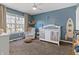 Bright Bedroom with a white crib, chair, and large window perfect for a peaceful, cheerful space at 14055 Mimosa Ct, Fishers, IN 46038