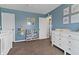 Bedroom with a cozy crib, dresser, and colorful decor, creating a playful and organized space at 14055 Mimosa Ct, Fishers, IN 46038