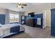 Well-lit primary bedroom featuring wainscotting, large window, and comfortable king bed at 14055 Mimosa Ct, Fishers, IN 46038