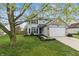 Charming two-story home featuring blue shutters, a well-manicured lawn, and an attached two-car garage at 14055 Mimosa Ct, Fishers, IN 46038