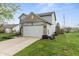 The side of a two-story home with siding and brick along with a two-car garage at 14055 Mimosa Ct, Fishers, IN 46038