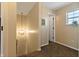 Bright hallway featuring carpeted floors, a decorative light fixture, and natural light at 14055 Mimosa Ct, Fishers, IN 46038