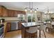 Well-lit kitchen with granite countertops, stainless steel appliances, and a central island for dining at 14055 Mimosa Ct, Fishers, IN 46038