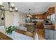 Eat-in kitchen with stainless steel appliances, kitchen island, and wooden cabinetry at 14055 Mimosa Ct, Fishers, IN 46038