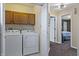 Convenient laundry room with modern washer and dryer, plus extra storage and hallway access at 14055 Mimosa Ct, Fishers, IN 46038