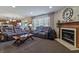 Inviting living room with a fireplace, large windows, and comfortable seating at 14055 Mimosa Ct, Fishers, IN 46038