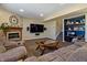 Cozy living room with a fireplace, built-in shelves, and a comfortable sectional sofa at 14055 Mimosa Ct, Fishers, IN 46038