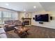 Spacious living room featuring a fireplace, large TV, and comfortable seating area at 14055 Mimosa Ct, Fishers, IN 46038