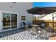 Inviting outdoor patio with ample seating, a gas fire pit, stylish rug, and a view of the backyard at 14055 Mimosa Ct, Fishers, IN 46038