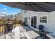Relaxing outdoor patio with comfortable seating, umbrella, and a grill, perfect for entertaining guests at 14055 Mimosa Ct, Fishers, IN 46038
