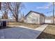 Backyard view with a large concrete patio and path to the garage at 1434 S Talbott St, Indianapolis, IN 46225