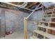 Unfinished basement with exposed brick, wooden stairs, and exposed pipes at 1434 S Talbott St, Indianapolis, IN 46225