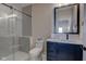 Modern bathroom with a glass shower, toilet and blue vanity at 1434 S Talbott St, Indianapolis, IN 46225