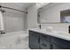 This bathroom has white tiled walls and floors, plus a double sink vanity with black hardware at 1434 S Talbott St, Indianapolis, IN 46225