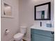 A modern powder room featuring a stylish vanity with white countertop and a framed mirror at 1434 S Talbott St, Indianapolis, IN 46225