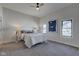 Bright bedroom with a ceiling fan, two windows and carpet flooring at 1434 S Talbott St, Indianapolis, IN 46225