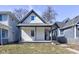 Charming home featuring gray trim, vertical siding, and a cozy covered front porch at 1434 S Talbott St, Indianapolis, IN 46225