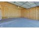 Unfinished interior of a large two-car detached garage with concrete flooring and unfinished walls at 1434 S Talbott St, Indianapolis, IN 46225