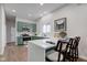 Modern kitchen features green cabinets, stainless steel appliances, white countertops, and a breakfast bar with seating at 1434 S Talbott St, Indianapolis, IN 46225