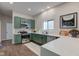 Charming kitchen features green cabinets, stainless steel appliances, and white countertops, creating a modern look at 1434 S Talbott St, Indianapolis, IN 46225