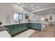 Well-designed kitchen featuring green cabinetry, stainless appliances, white counters, and an eat-in breakfast bar at 1434 S Talbott St, Indianapolis, IN 46225