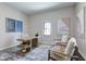 Comfortable office space with a unique wooden desk, artwork, a window, and inviting seating at 1434 S Talbott St, Indianapolis, IN 46225