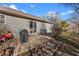 Back patio with covered grill, chairs, and steps leading to the grassy yard at 15214 Ten Point Dr, Noblesville, IN 46060
