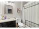 Functional bathroom featuring a vanity, toilet, mirror, and shower with a striped curtain at 15214 Ten Point Dr, Noblesville, IN 46060