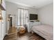 Cozy bedroom features a window, drawers, mirror, and minimalistic decor with hardwood floors at 15214 Ten Point Dr, Noblesville, IN 46060